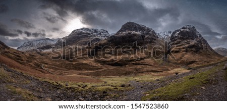 Panoramic view of Highland's Glencoe landscape, three sisters mountains and dramatic cloudy sky.