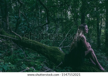 Woman in the woods on a tree