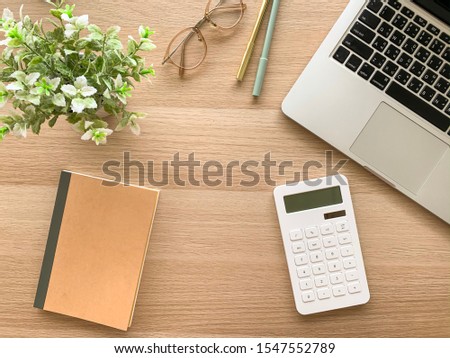 Flat lay of workspace desk of stationery and laptop with calculator, business and office concept
