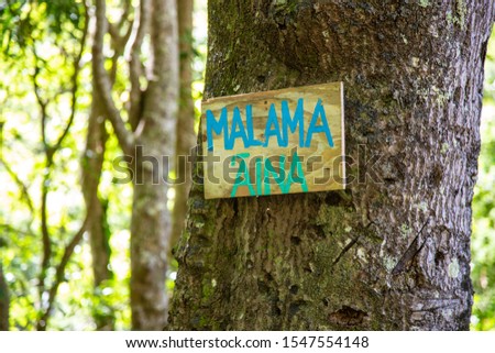 Malama Aina Hawaiian sign symbol board on tree care for nature environmental Maui eco ecology protect