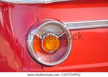 round headlights of old retro cars, red brake lights and yellow turn signals. the automotive hobby, the rules of the road