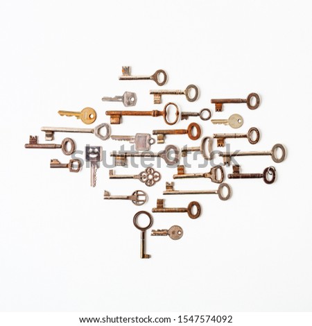Creative composition made with various old keys on white background. Retro pattern. Security concept. Flat lay, top view
