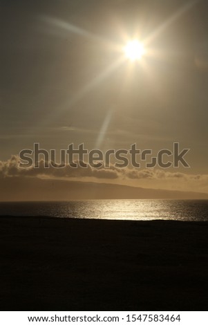 Sunset sunburst over sea with cloudy in sky 