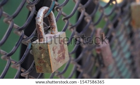 A rusty metal lock on a fence, its a meaning of love       