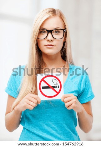 picture of woman with smoking restriction sign .