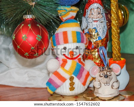 Christmas and New Year card with cute rat, snowman and Santa Claus. Ornaments symbol of the year on the Chinese calendar ate in the background. Winter holiday concept