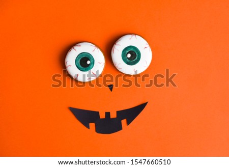 Halloween conten parties and decorations. Black-orange background and gingerbread cookies. Decor