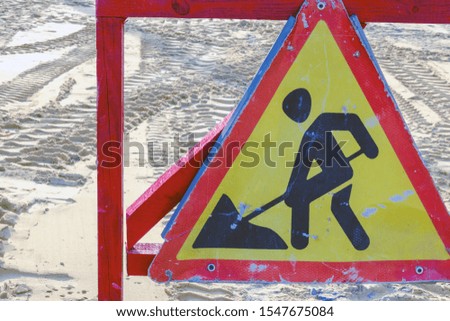 warning of repair or construction of a road triangular road sign. located at the place of work of construction equipment