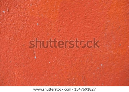 Cement wall with a bright orange color.