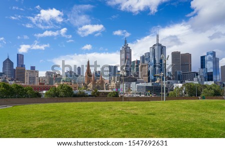 Empty green grass with beautiful Melbourne cityscape skyline background  .