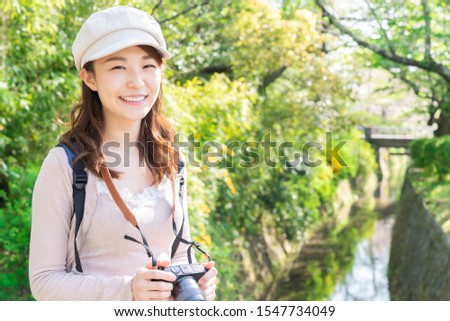 Beautiful young asian woman who travels in Kyoto,camera,Japan