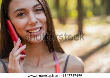 Close up picture of a beautiful young woman talking on her smartphone