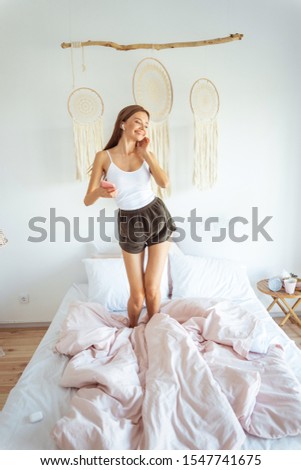 Playful mood. Cute female expressing positivity while listening to energetic music