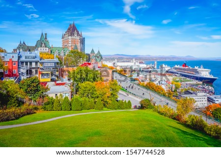 Skyline view of Old Quebec City with iconic Chateau Frontenac and Dufferin Terrace against St. Lawrence river in autumn sunny day, a national historic site of Canada, most famous landmark of Quebec. Royalty-Free Stock Photo #1547744528