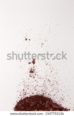 This is a photograph of a Burgundy Powder Eyeshadow isolated on a White Background 
