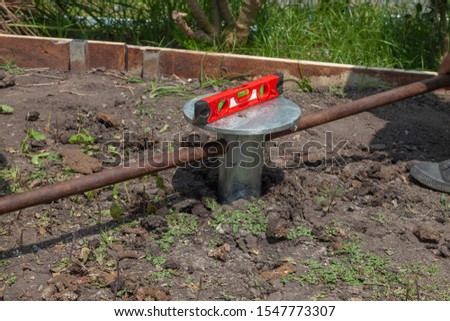 Worker manual drilling hole and Measure the water level tool on the ground at sunny day