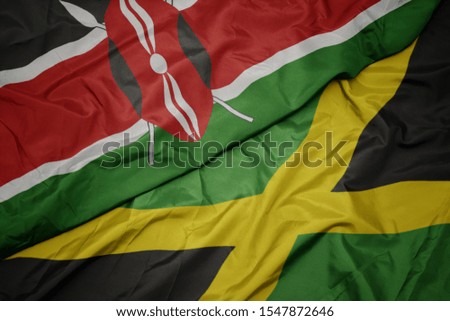 waving colorful flag of jamaica and national flag of kenya. macro