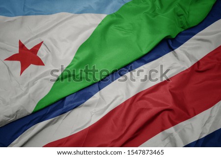waving colorful flag of costa rica and national flag of djibouti. macro