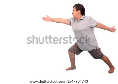 A senior Asian woman is practicing yoga by spreading both hands and two feet from the body and standing calmly on white background. There is a copy space. 
