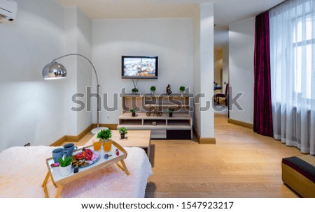 Modern interior of light spacious studio apartment. Bedroom with furniture.