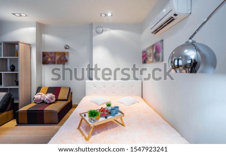 Modern interior of light spacious studio apartment. Bedroom with furniture.