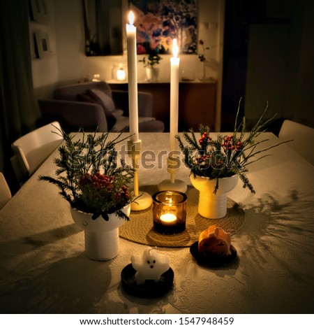 Candles Halloween style with cozy lighting and interior around a table.