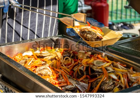 Jamaican fish and vegetable street food at Notting Hill Carnival 2019 Royalty-Free Stock Photo #1547993324