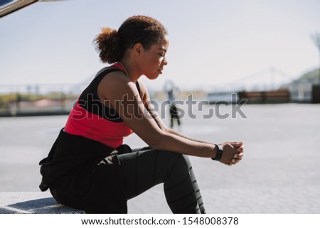 Sporty young woman resting outdoors stock photo