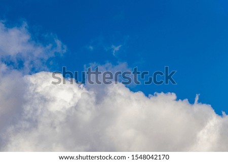 White curly cloud below on blue sky phongi
