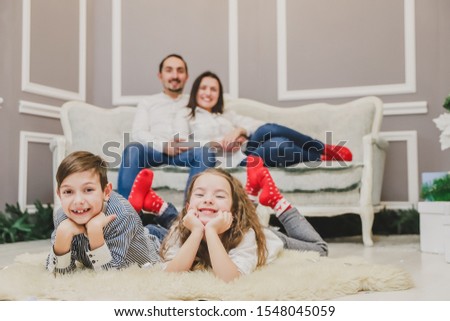 Lovely family members in red socks are in anticipation of new year.