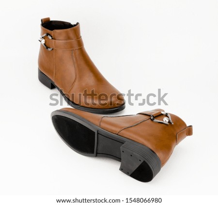 Elegant woman's brown leather boots.
