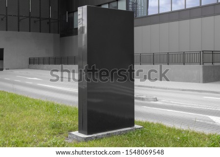 Mockup of blank black vertical advertising sign at the mall or shopping centre parking entrance