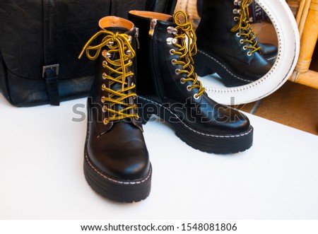 Military boots and bag. Fashion background.