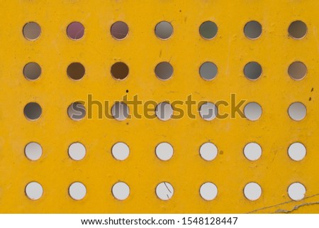 Yellow iron plate with evenly round holes