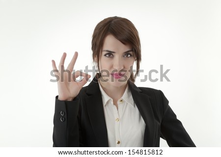 Confident young businesswoman showing OK sign 