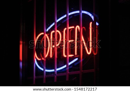 A neon open sign in the window