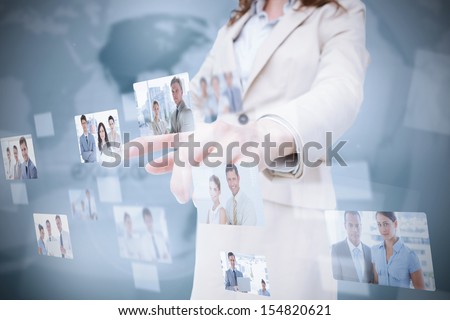 Stylish businesswoman presenting coworkers pictures on digital interface
