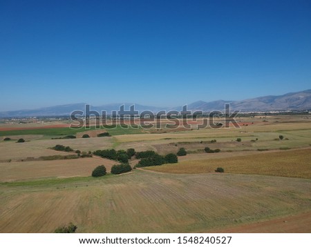 Aerial drone landscape photo from high above of fields in a clear weather summer day 
