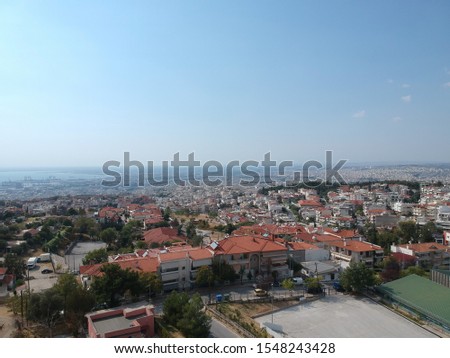 Aerial drone landscape photography of a byzantine castle that was former jail named "Yeti Kule" overlooking the city and port of Thessaloniki, Greece in a clear summer day