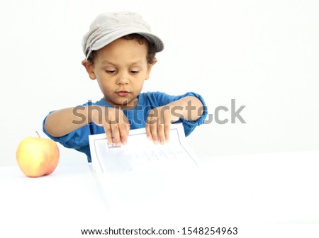 boy with apple and book going back to school with book on white background stock photo