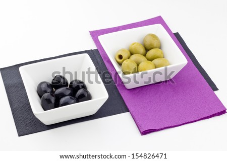 black and green olives on bowl on white background