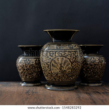 old vases in a wood table in black background Royalty-Free Stock Photo #1548283292