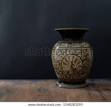 old vases in a wood table in black background Royalty-Free Stock Photo #1548283295