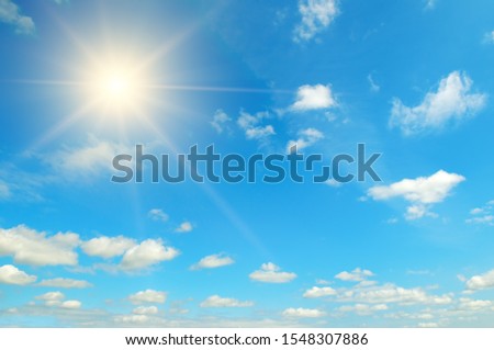 Couds in the blue sky. Bright midday sun illuminates the space. Royalty-Free Stock Photo #1548307886
