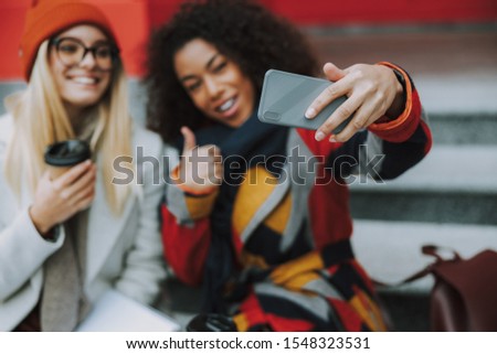 Happy young lady holding smartphone in hand stock photo