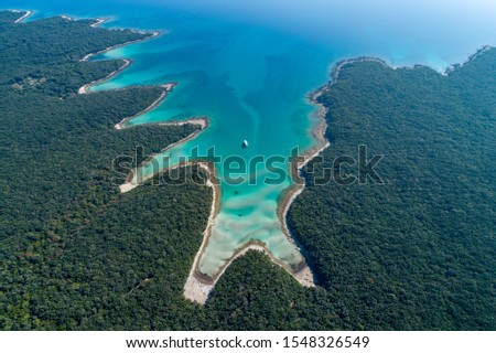 Aerial view of sea and beach in a lagoon on Cres ( isola Cherso )  Island Croatia, close to Punta Kriza; Punta Croce. It is a part of national where rocks and sand and forest merge on a coast.  Royalty-Free Stock Photo #1548326549