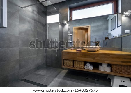 Modern interior design - bathroom in gray and wooden finishing Royalty-Free Stock Photo #1548327575