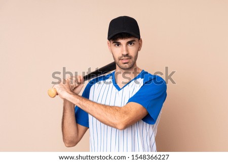 Young man over isolated background playing baseball