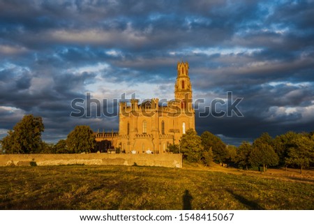 Church Notre Dame de la Dreche outside Albi city with dramatic clouds and sunset golden sunlight
