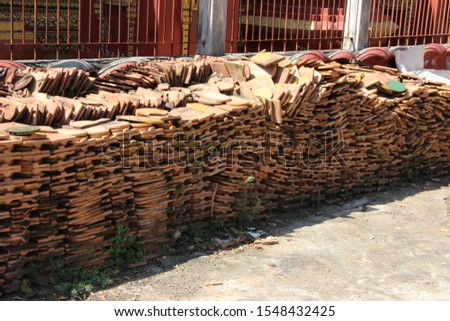 Pile or stack of roof tiles for pagoda construction in Siem Reap, Cambodia. Typical of Asian construction.
